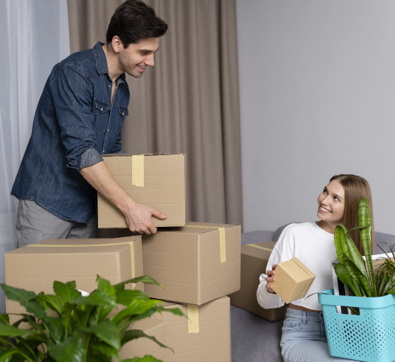 couple handling boxes belongings after moving new house